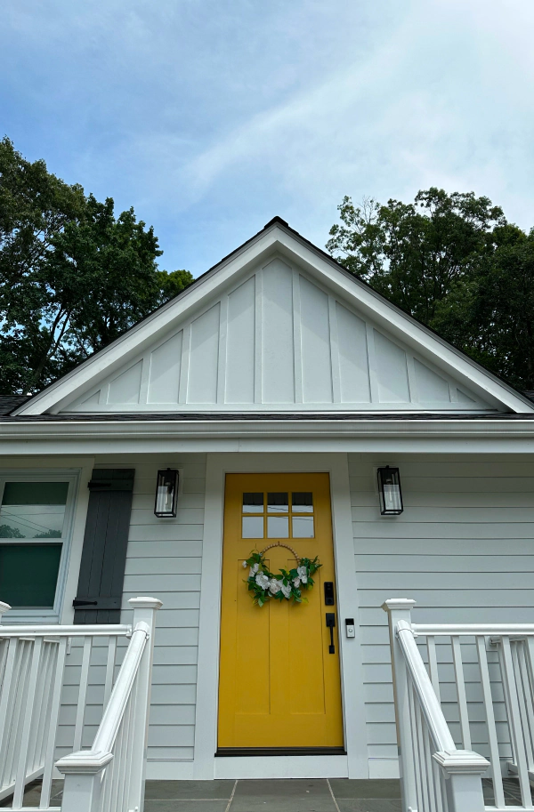 vynil siding in a house with a yellow door