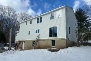 Ladders perched on the side of a two story home in Norwalk, CT